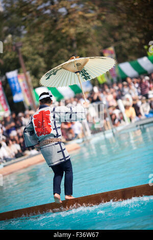 traditional Japanese yukata balancing on square log on water Stock Photo