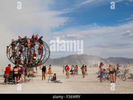 Burners gather in the playa during the annual Burning Man festival in the desert August 30, 2014 in Black Rock City, Nevada. Stock Photo