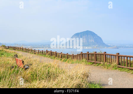 Landscape view from Olle trail No.10 at Songaksan course in Jeju island, Korea. Sanbangsan is a famous volcanic mountain in Seog Stock Photo