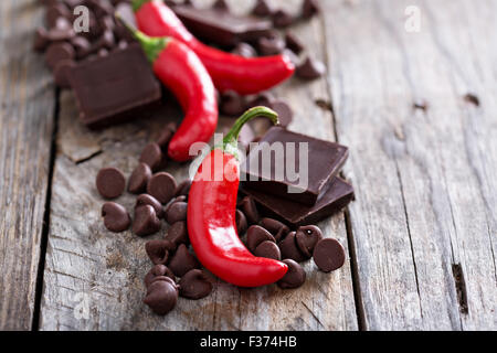 Dark chocolate pieces and chips with red hot chilli pepper Stock Photo