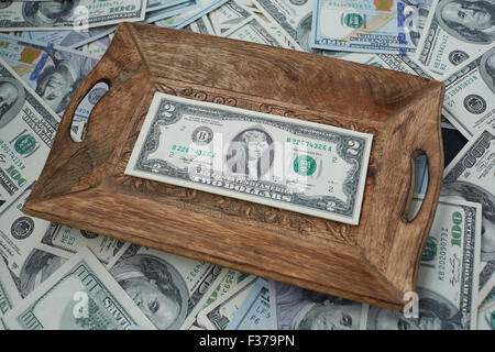 money on a wooden tray, two USD Stock Photo