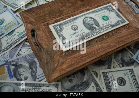 money on a wooden tray, two USD Stock Photo