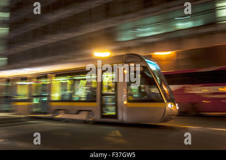 Night time Dublin, Ireland. A LUAS tram with speed blur Stock Photo