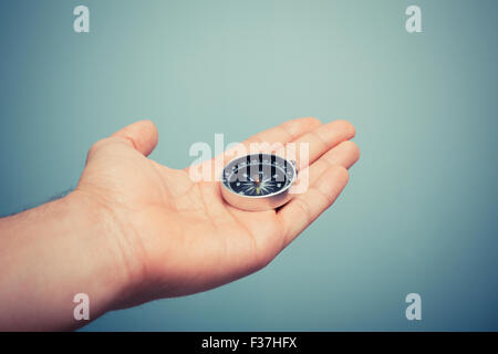 A hand is holding a compass Stock Photo