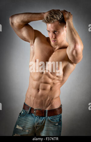 https://l450v.alamy.com/450v/f37ktr/blond-young-man-with-well-trained-body-abs-and-pecs-and-wearing-a-f37ktr.jpg