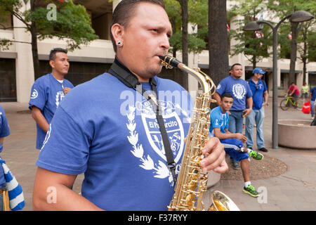 Man playing saxophone outdoors - USA Stock Photo
