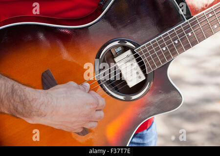 Man playing acoustic-electric guitar - USA Stock Photo