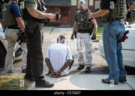 US Marshals Service agents arrest a gang member during Operation Salt City September 1, 2015 in Syracuse, New York. The operation resulted in the arrest of 248 suspects, 22 firearms, more than $237,000 in U.S. currency, 70 grams of heroin, 266 grams of cocaine, and 723 grams of marijuana. Stock Photo