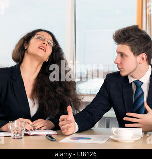 Disagreed female executive and young employee Stock Photo