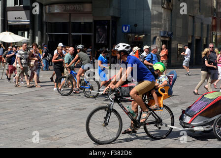 Father and child on bicycle at Stephansplatz, Vienna, Austria Stock Photo