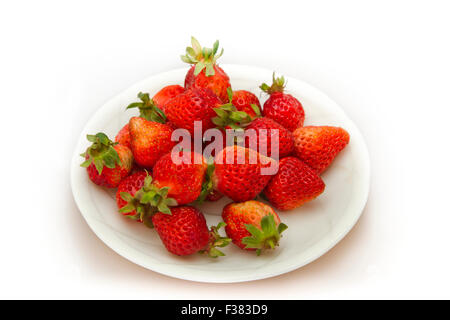 Fresh strawberries were placed in white plate on a white background Stock Photo