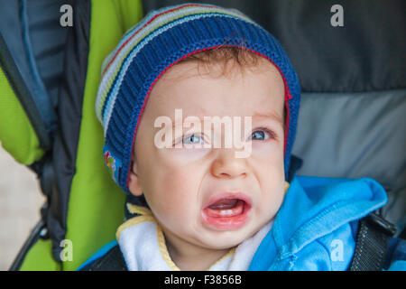 10 months old baby boy portrait in the stroller. Stock Photo