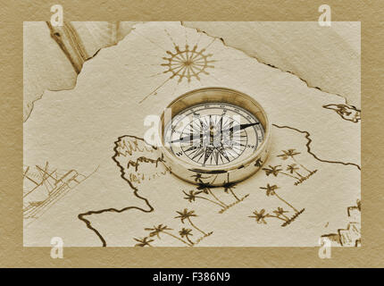 a compass lies on an old treasure map Stock Photo