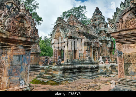 Stone buildings of the ancient Banteay Srei temple covered with intricate carvings. Angkor Archaeological Park, Siem Reap Province, Cambodia. Stock Photo
