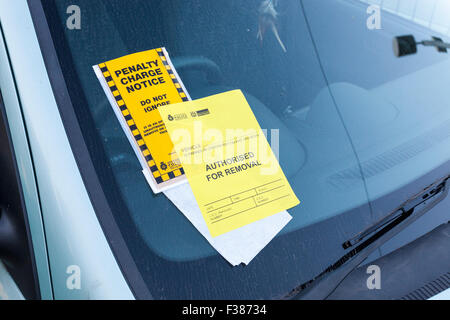 Parking ticket, UK. Penalty Charge notice with Authorised For Removal notice added and attached to a windscreen, Nottingham, England, UK Stock Photo