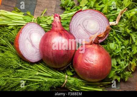 Onions, Parsley and Dill on wooden table Stock Photo