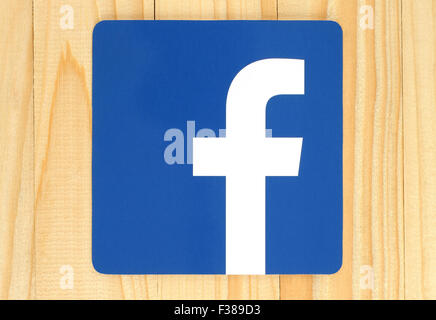 KIEV, UKRAINE - APRIL 30, 2015: Facebook logo sign printed on paper and placed on wooden background. Stock Photo