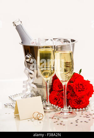Wedding rings with writing card and champagne as postcard Stock Photo