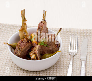 Grilled rack of lamb with carrot onion and capers Stock Photo
