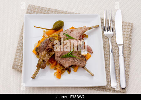 Grilled racks of lamb with carrot, onion, garlic, top view Stock Photo