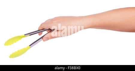 Cooking tongs in female hand isolated on a white background Stock Photo