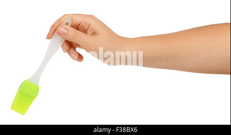 Silicone pastry brush in female hand isolated on white background Stock Photo
