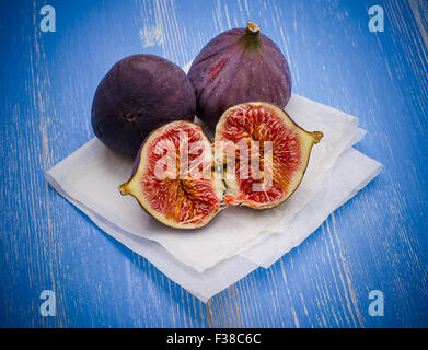 Three ripe figs on baking paper background, top view Stock Photo