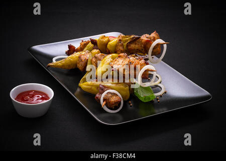 Skewers with meat, pepperoni on black, horizontal Stock Photo