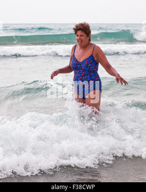 Woman in cold sea. Stock Photo