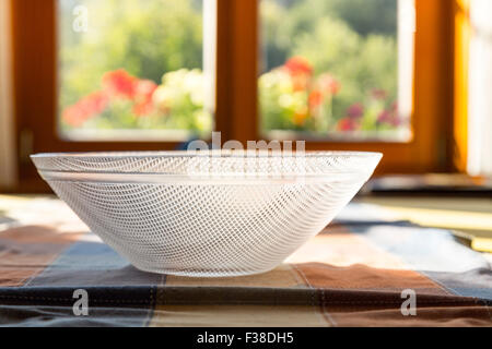 close up of a simple glass bowl on a table Stock Photo