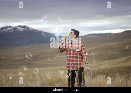 boy blowing a huge bubble Stock Photo