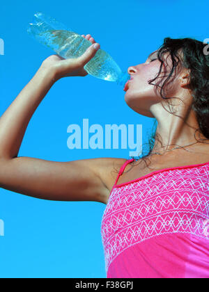 Thirst. Young woman drinking cold water in hot day Stock Photo