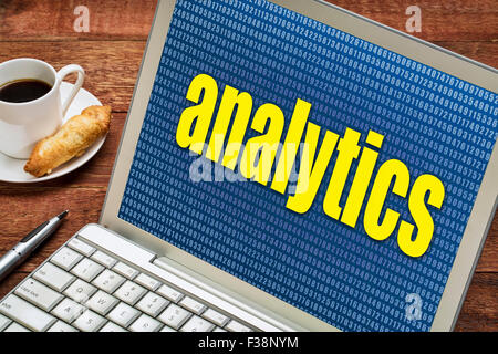 analytics word against random number background on a laptop with a cup of coffee Stock Photo