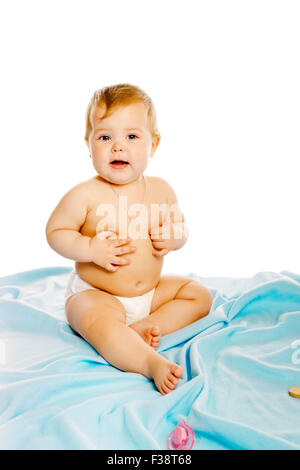 baby in diaper sitting on a blue blanket. Studio. Isolated Stock Photo