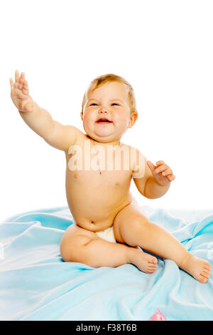 baby in diaper sitting on a blue blanket. Studio. Isolated Stock Photo