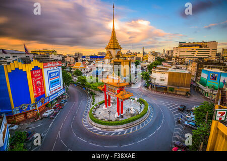 The Chinatown gate traffic circle with Wat Traimit behind in Bangkok, Thailand. Stock Photo