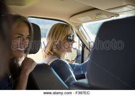 Smiling women driving in car