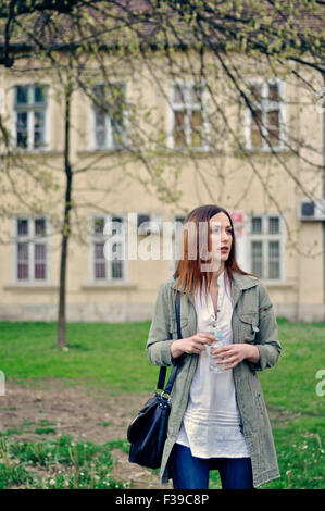 Portrait of a young woman on city street Stock Photo
