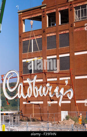 Keynsham, Somerset, UK. 2nd October, 2015. Built by the Fry familiy who merged with Cadbury's after the first world war, the Somerdale factory produced favourite confections such as Fry's Chocolate Cream, Crunchie and Cadbury's Cream Eggs. The iconic Cadbury's sign has overlooked the local area for many years.  The company was taken over by Kraft and  production moved to Poland. The site is now being developed by Taylor Wimpey for housing and Freeman Retirement Living are converting the main building for retirement housing. Credit:  Mr Standfast/Alamy Live News Stock Photo