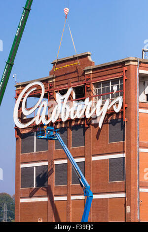 Keynsham, Somerset, UK. 2nd October, 2015. Built by the Fry family who merged with Cadbury's after the first world war, the Somerdale factory produced favorite confections such as Fry's Chocolate Cream, Crunchie and Cadbury's Cream Eggs. The iconic Cadbury's sign has overlooked the local area for many years.  The company was taken over by Kraft and  production moved to Poland. The site is now being developed by Taylor Wimpey for housing and Freeman Retirement Living are converting the main building for retirement housing. Credit:  Mr Standfast/Alamy Live News Stock Photo