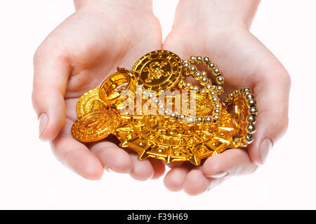 Handful of pirates coins in palm hands isolated on white Stock Photo