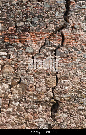 Cracked red brick wall of a medieval fortress Stock Photo