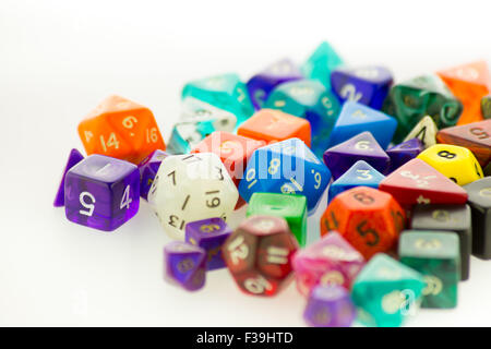 Close up of a large pile of multicolored gaming dice on a white surface Stock Photo