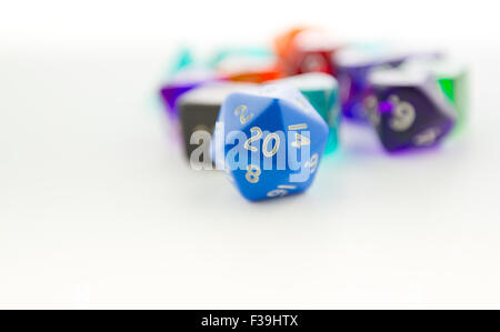 Macro shot of twenty sided dice with other dice out of focus on a white background Stock Photo