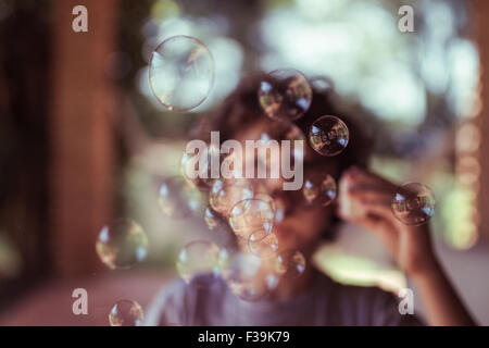 Boy blowing bubbles Stock Photo