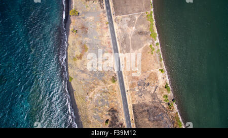 Aerial view of a Road between the ocean and Lombok island, Indonesia Stock Photo