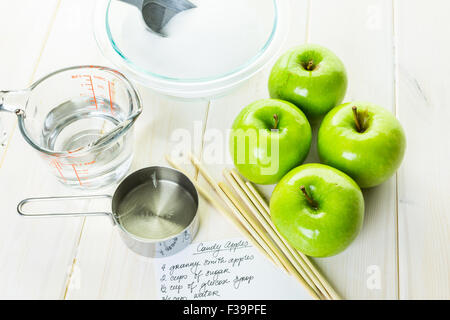 Ingredients for preparing homemade black candy apples. Stock Photo