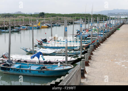 Small fishing boats dock at Chung-Kang wharf near Guandu Temple, Beitou District, Taipei City, Taiwan Stock Photo