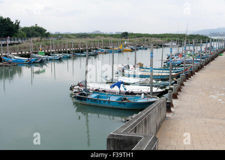 Small fishing boats dock at Chung-Kang wharf near Guandu Temple, Beitou District, Taipei City, Taiwan Stock Photo