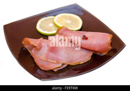 Smoked tuna on black plate on white background Stock Photo